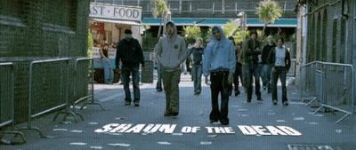 Group Walking Down Street With Shaun Of The Dead Painted On Ground GIF