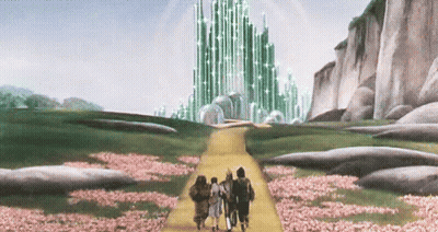 Group Walking Down Yellow Path To Green Building GIF