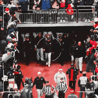 Group Walking On Red Carpet With Sloopcast.com On Fence GIF