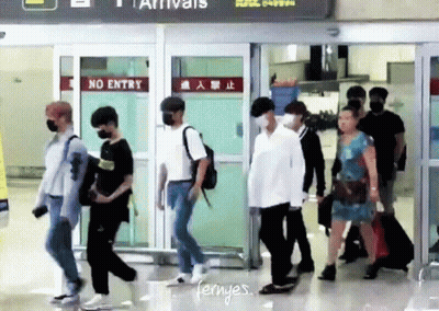 Group Walking Through Airport With No Entry Sign GIF