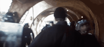 Group Walking Through Building Tunnel GIF