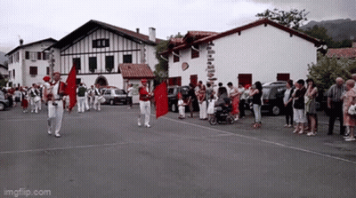 Group Walking With Red Flag In Front Of Building Saying Imgflip.com GIF