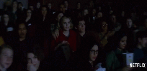 Group Watching Movie With Netflix Logo On Bottom GIF