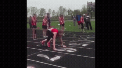Group Watching Runner On Track GIF