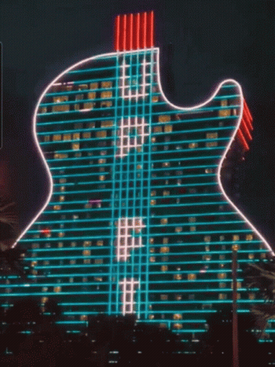 Guitar-Shaped Building Lit With Neon Lights GIF