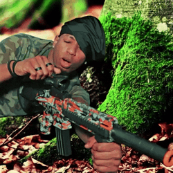 Gunner Lying Down Behind A Tree GIF