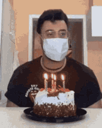 Guy Blowing Birthday Candles Using Hair Dryer