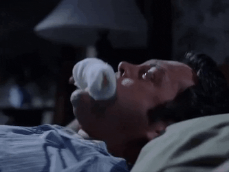 Guy Gagged While Lying In Bed GIF