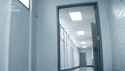 Guy Walking Fast In Hall Holding Files GIF