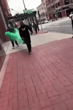 Guy Walking With Green Smoke Behind Him GIF