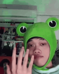 Guy Wearing Keroppi Cap With Finger Heart Sign GIF