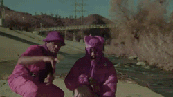 Guys With Purple Costume Pointing