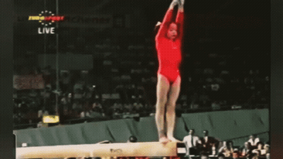 Gymnast Performing Trick On Balance Beam GIF