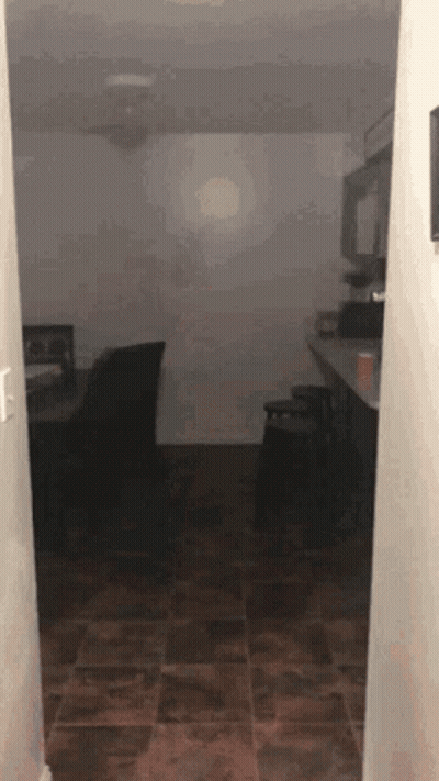 Hallway Leading to Dark Room With Ceiling Fan