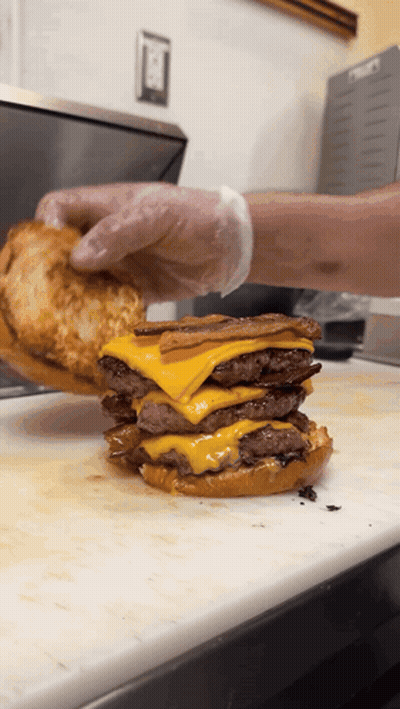 Hamburger Stacked On Another Hamburger On Cutting Board GIF