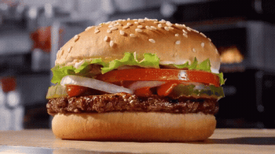 Hamburger With Lettuce Tomato Onions Cheese On Bun GIF