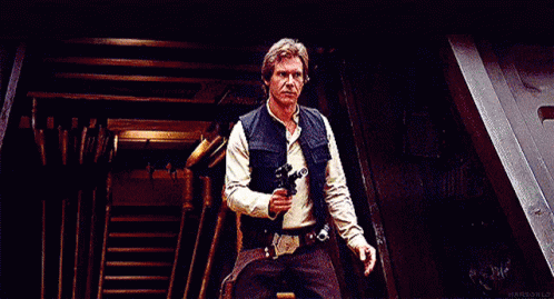 Han Solo From Star Wars Is Holding A Gun In His Hand And Making A Funny Face . GIF