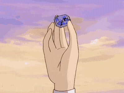 Hand Holding Blue Object With Letter X GIF
