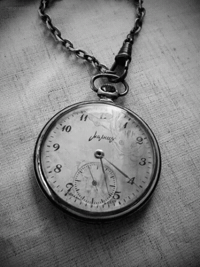 Hand Holding Clock Showing 1 And 5 GIF