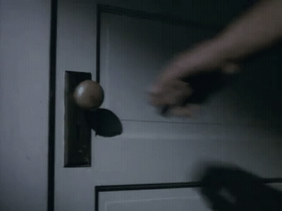 Hand Holding Door Handle In Dark Room GIF