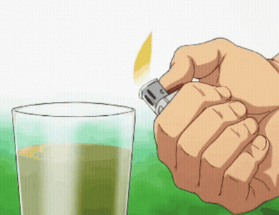 Hand Holding Lighter Next To Glass Of Liquid GIF