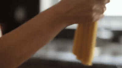 Hand Holding Piece Of Food GIF