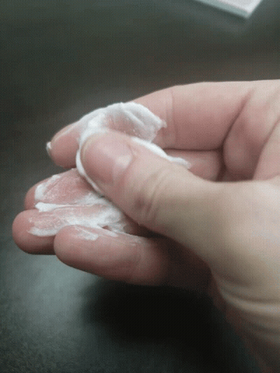 Hand Holding White Liquid GIF