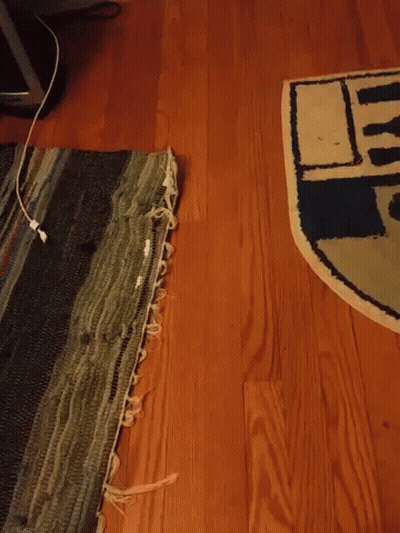 Hand Making OK Sign In Front Of R2D2 Rug GIF
