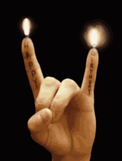 Hand Making Rock And Roll Sign With Candles GIF