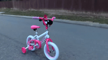Hand Puppet Chasing Down Toy Bike GIF