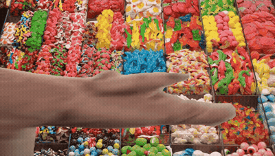 Hand Reaching For Candy Display GIF