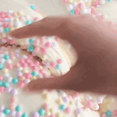 Hand Reaching For Cookie With Sprinkles GIF