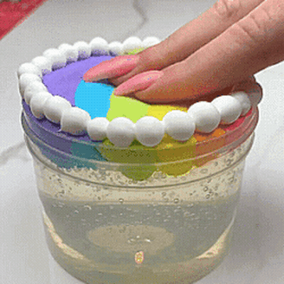 Hand Reaching For Rainbow Item In Container GIF