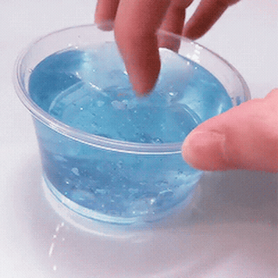 Hand Reaching Into Blue Liquid GIF