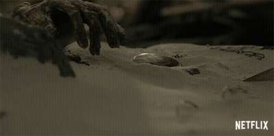 Hand Reaching Into Sand GIF