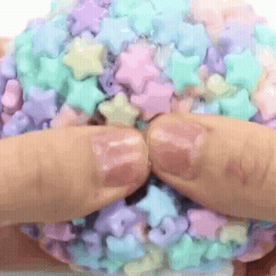 Hands Holding Candy Ball With Stars GIF