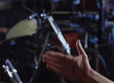 Hands Holding Cigarette Near Drum Set GIF