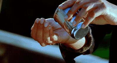 Hands Holding Small Silver Object GIF