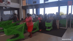 Happy Black Friday People Entering Store With Carts GIF