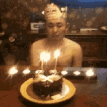 Happy Guy Blowing Rows Of Birthday Candles