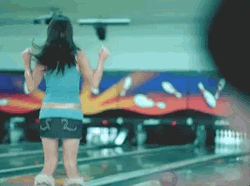 Happy Woman Jumping In Bowling Alley GIF