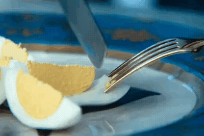 Hard Boiled Egg Cut In Half With Knife And Fork GIF