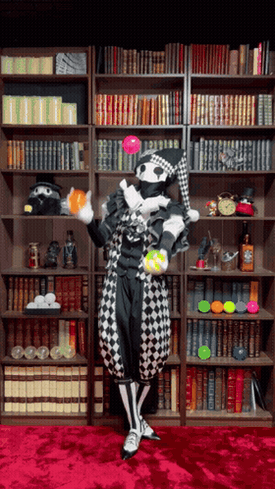 Harlequin Juggling Balls Near Bookshelf GIF