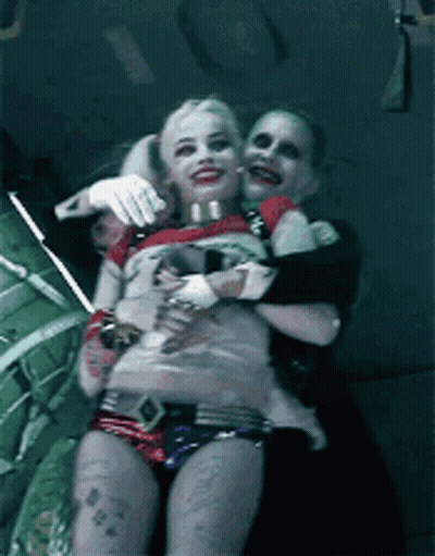 Harley Quinn And The Joker Are Posing For A Picture Together GIF