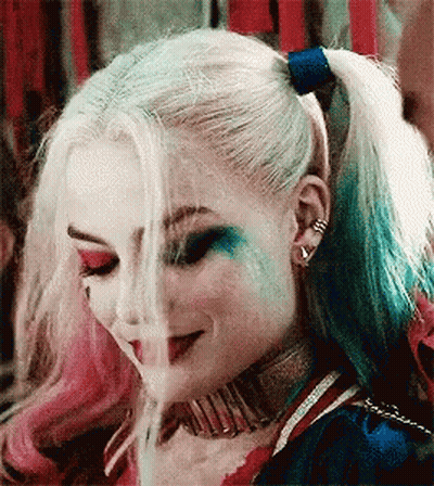 Harley Quinn From Suicide Squad Is Smoking A Cigarette While Wearing A Ponytail . GIF