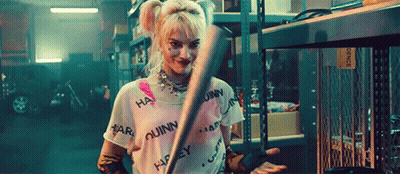 Harley Quinn Holding Bat In Garage GIF