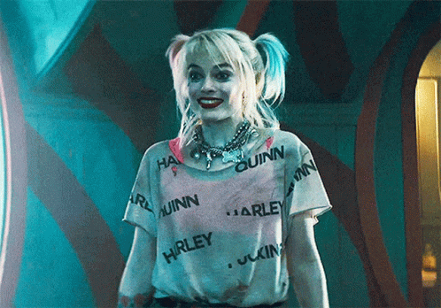 Harley Quinn Is Wearing A White Shirt With Harley Quinn Written All Over It . GIF