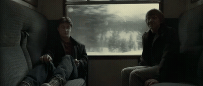 Harry Potter And Ron Weasley Are Sitting On A Train Looking Out Of A Window . GIF