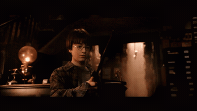 Harry Potter Is Holding A Wand In His Hand GIF