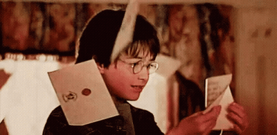 Harry Potter Is Reading A Letter From Harry Potter While Wearing Glasses . GIF